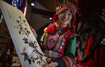 Cooperative specializing feather art in China's Yunnan boosts locals' income